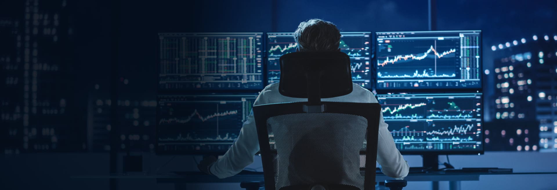 Man sitting in chair analysing market data